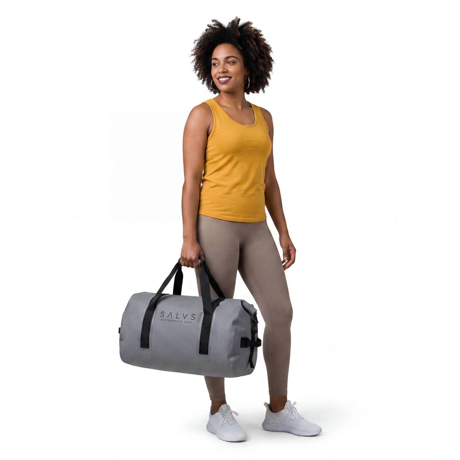Woman holding a grey SALVS 60L duffel in a white studio.